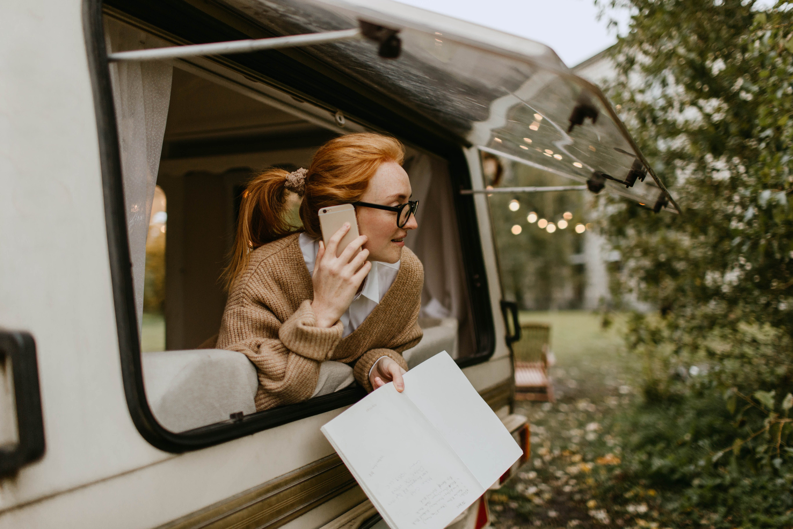 Woman Looking Outside A Trailer